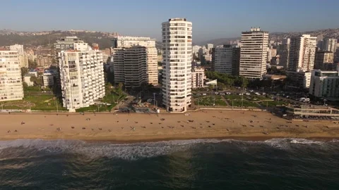 Aerial Pull-Back from Viña del Mar Beach Revealing City Skyline at Sunset Video stock 322697185