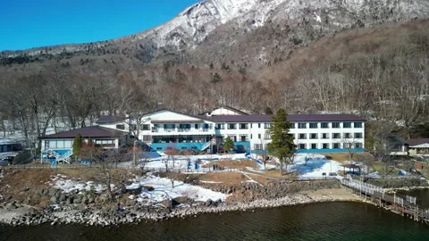 Aerial Pull Back From Winter Lake Hotel Stock Footage 336811698