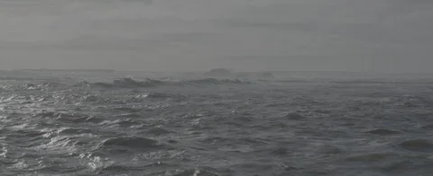 Aerial pull low over rough ocean and waves in Half Moon Bay Stock Footage 107321883