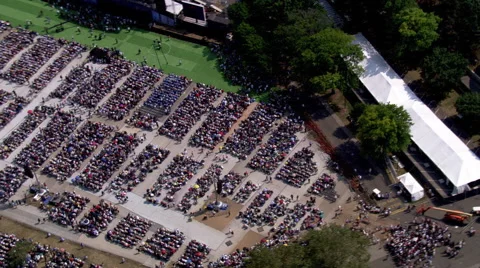 Aerial pull-out from crowd at open-air event in Flushing Meadows, NY Stock Footage 59455307