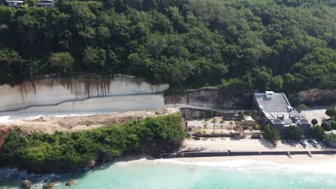 Aerial pull out from Pandawa cliffside Stock Footage 329188181