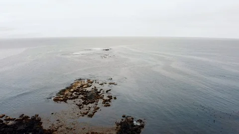 Aerial pull out revealing view of a lighthouse in Akranes in West Iceland Stock Footage 118946693
