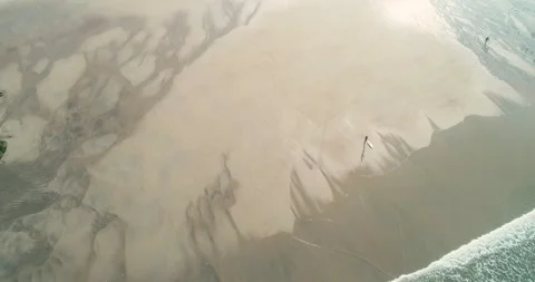 Aerial pull out shot of a lonely surfer on a vast beach The Concept of Solitu Vídeo Stock 317387372