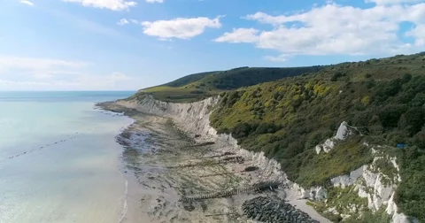 Aerial pull out view of chalky white cliffs and the sea in Southern England Stock Footage 80417172