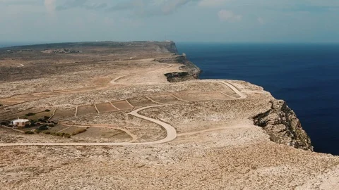 Aerial pull out view of the coastline of the island of Lampedusa (Italy) Stock Footage 119790758