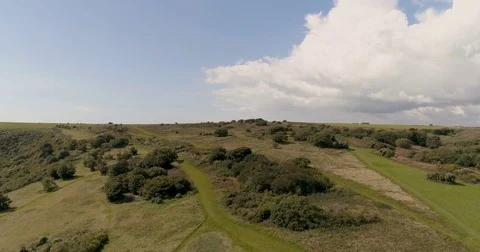 Aerial pull out view of the English countryside revealing the sea Stock Footage 80165488