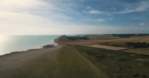 Aerial pull out view of a lighthouse on a cliff area by the sea Stock Footage 67121578
