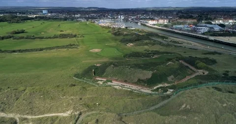 Aerial pull out view from a links golf course in Southern England Stock Footage 80989576