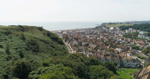 Aerial pull out view of the old town of Hastings in England and the beach Stock Footage 80612213