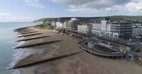 Aerial pull out view of the seafront and the beach of Eastbourne Stock Footage 80163448