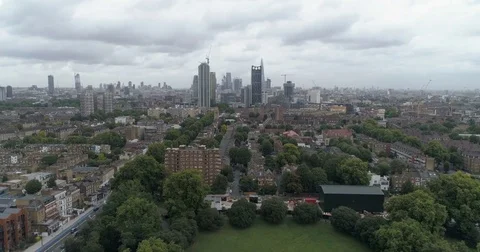 Aerial pull out view of the skyline of the City of London from the South Stock Footage