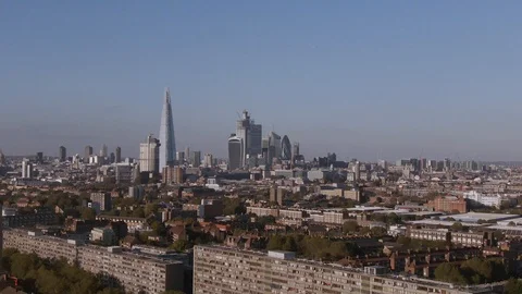 Aerial pull out view of the skyline of the City of London from the South Stock Footage 97143967