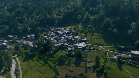 Aerial pull out view of a typical village in Aosta valley in the Italian Alps Stock Footage 113334423