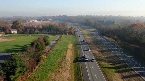 Aerial pullback above interstate highway in United States. Autumn fall Stock Footage 149473128