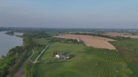 Aerial pullback above Po River farmland and orchards near Castelvetro Stock-Footage 336335651