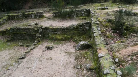 Aerial pullback above tiered housing outlining rock walls on ruins in Vídeo Stock 263732441