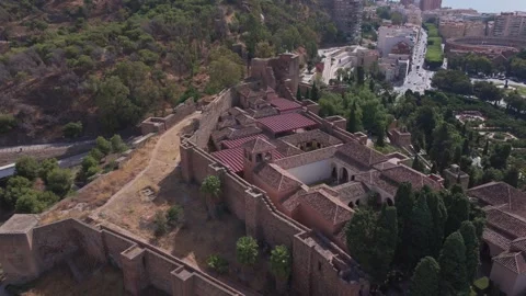 Aerial pullback from Alcazaba fortress in Malaga tilting up to reveal Video stock 334633663