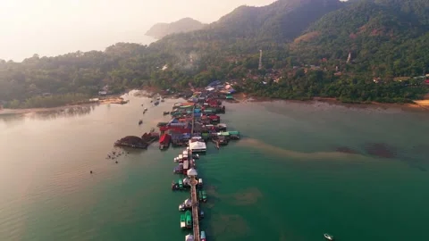 Aerial Pullback Along Koh Chang’s Pier with Docked Boats and Blue Ocean Stock-Footage 301845572