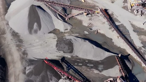 Aerial Pullback Along Quarry Conveyor and Gravel Piles Stock Footage 331836358