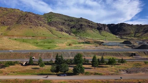 Aerial Pullback Along Scenic Mountain Highway with Moving Traffic Stock Footage 339771471