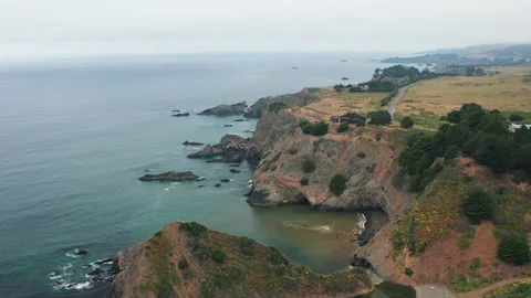 Aerial pullback ascending shot of Pacific Ocean Cliffs and waves in California Stock Footage 200794634