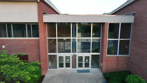 Aerial pullback of brick elementary school in America. View from exterior Stock Footage 196269298
