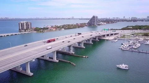 Aerial pullback of bridge over water in Miami Stock-Footage 83229614
