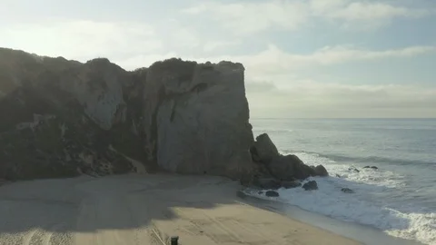 Aerial pullback of a cliff on the beach. Stock Footage 96036009