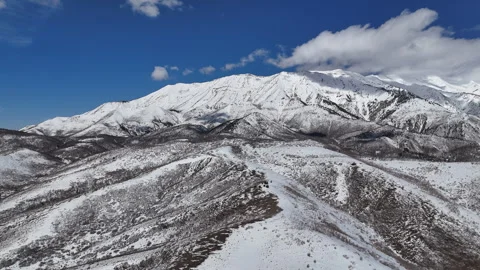Aerial-Pullback-Clouds in blue sky over snowy mountain Stock Footage 267045209