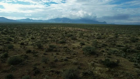 Aerial pullback of a desert mountain range with obscured peaks Stock Footage 211852317