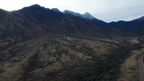 Aerial pullback of desert peaks with a dusting of snow Stock Footage 274290022