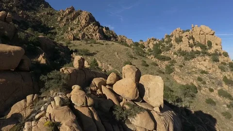 Aerial pullback of desert rock towers and boulders Stock Footage 98488872