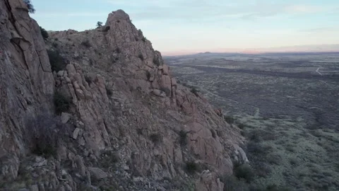 Aerial pullback of dramatic rock formations in desert mountains Stock Footage 331143805