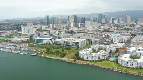 Aerial pullback drone shot of downtown Oakland, harbor, building, condos Stock Footage 308321527