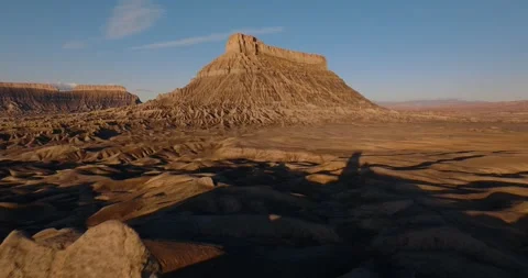 Aerial Pullback from Factory Butte Across Utah Desert Ridges Video stock 333834713