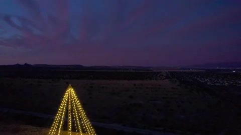 Aerial pullback of a giant Christmas tree light display at night Stock Footage 228810924