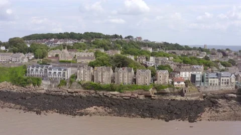 Aerial pullback from grand Victorian beach-front houses to reveal Clevedon Pier Stock Footage 144783168