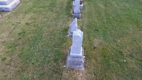 Aerial pullback of gravestones in a cemetery Stock Footage 77342323