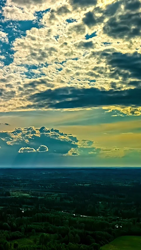 Aerial Pullback Hyperlapse of Sun Rays Breaking Through Clouds Over Rural Latvia Stock Footage 345116351