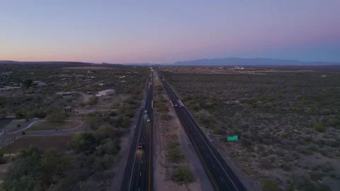Aerial pullback of an interstate highway in the desert at dusk Stock Footage 232775353