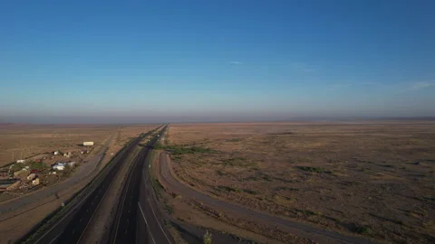 Aerial pullback of an interstate highway through the desert Stock Footage 197469421