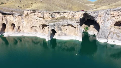Aerial Pullback from Lakeside Caves Along Crystal Blue Water Stock-Footage 340109761