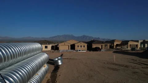 Aerial pullback of large drain pipes at a construction site Stock Footage 188202253