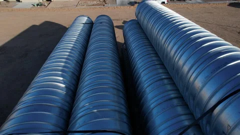 Aerial pullback of large drain pipes at a construction site Stock Footage 233698460