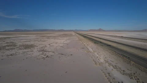 Aerial pullback of a lonely stretch of highway through a barren desert Stock Footage 197070315