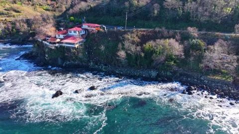 Aerial Pullback From Luxury Coastal Villa Toward Blue Sea Stock Footage 343119362