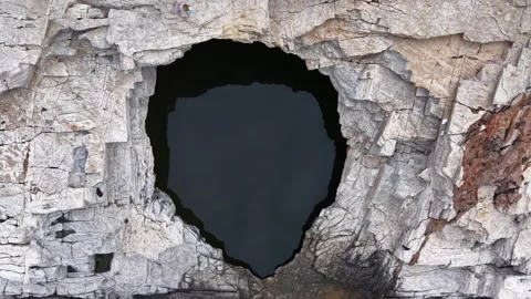 Aerial Pullback From Natural Cave in Coastal Cliff Stock Footage 340508006