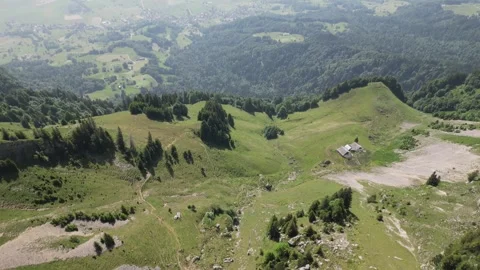 Aerial Pullback Over Alpine Trails to Hazy Valley Farmland Stock Footage 323331194