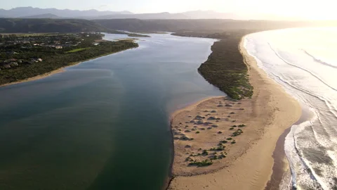 Aerial pullback over Keurbooms River estuary mouth at sunrise in Plettenberg Bay Stock Footage 333996433