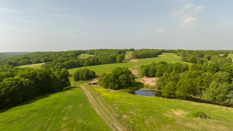Aerial Pullback Over Lush Landscape Near Outdoor Firing Range In Leach, Stock Footage 246732080
